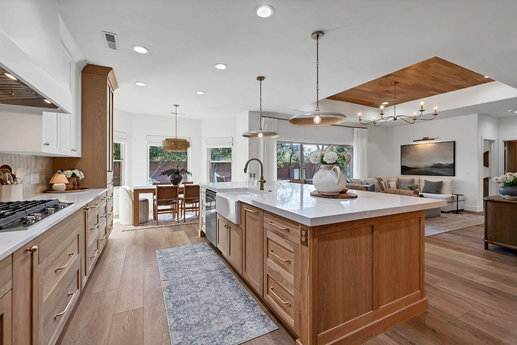 Bright remodeled kitchen with white and natural wood cabinetry