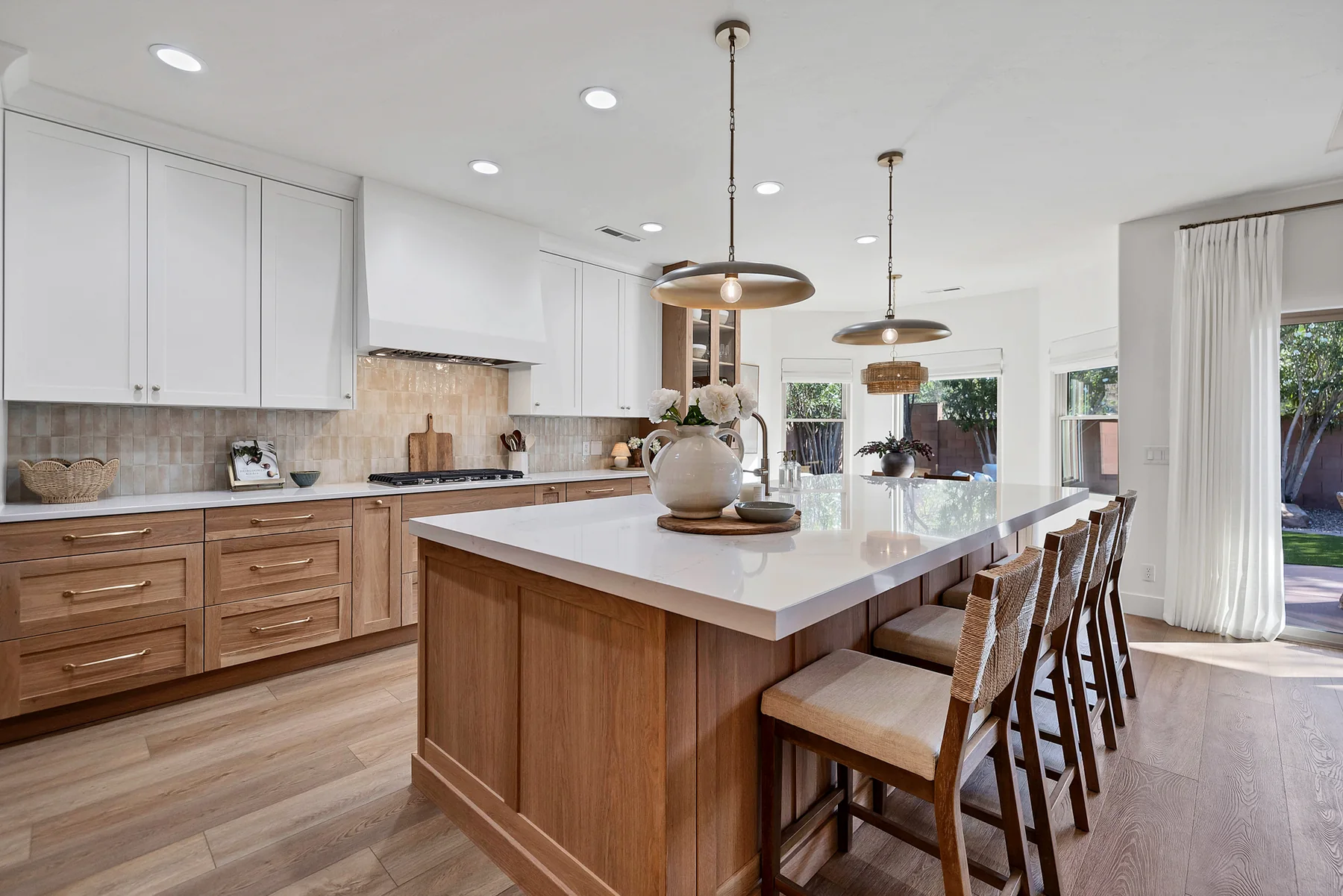 Kitchen island and range wall in warm oak and soft white