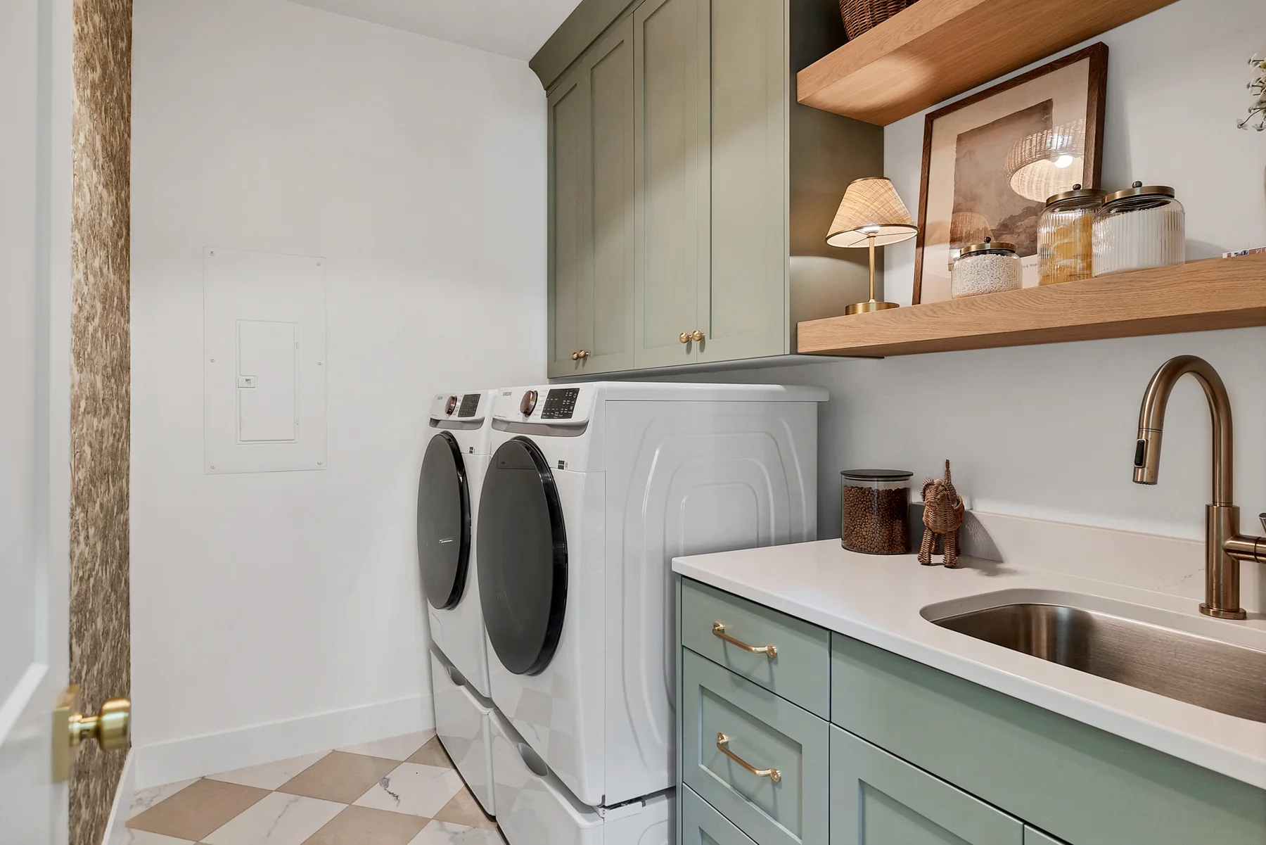Sage green laundry room cabinetry