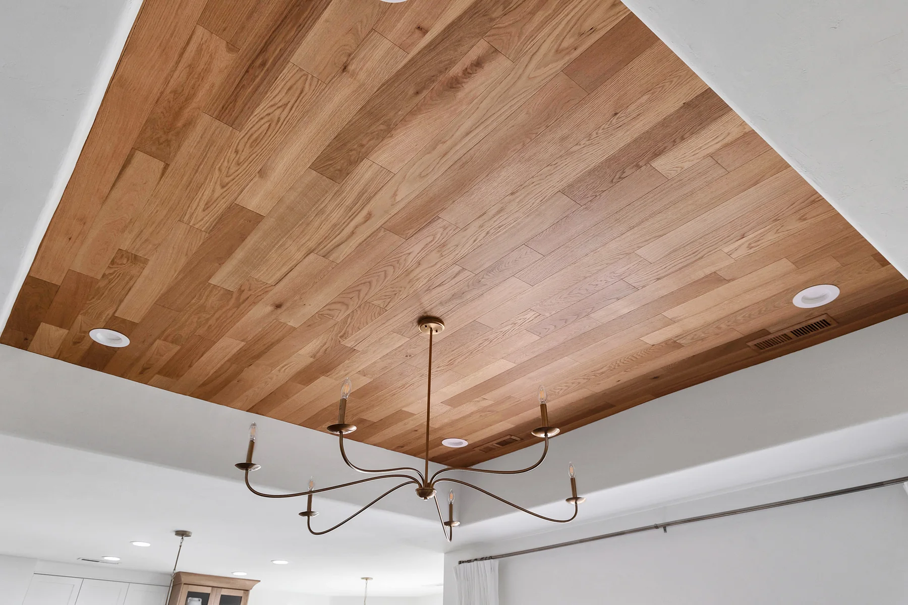 Inset natural wood ceiling and sculptural chandelier